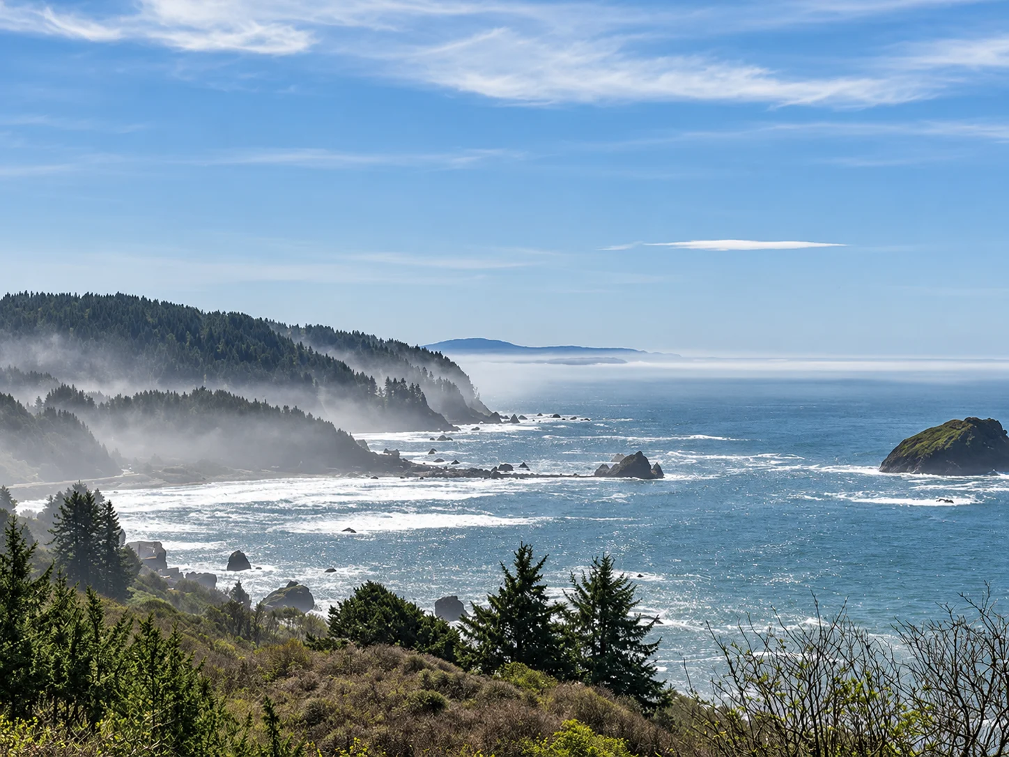 Misty Oregon coastline with sea stacks