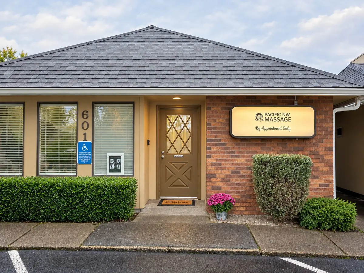 Front of the studio at Suite 601 with the lit Pacific NW Massage sign beside the door