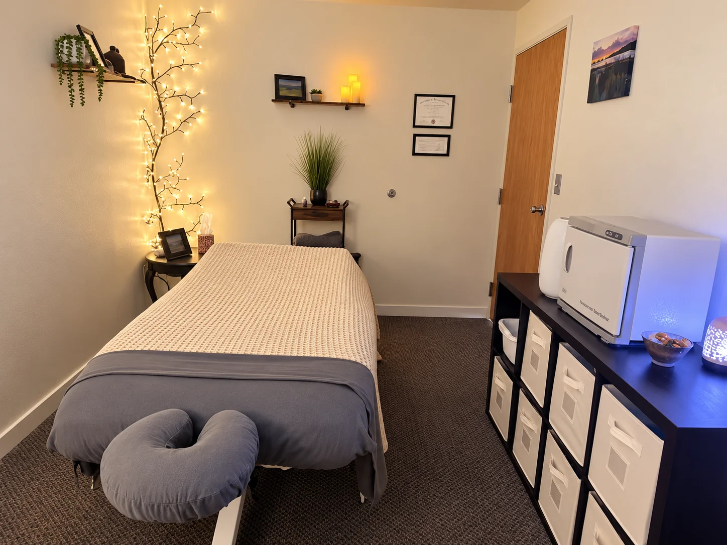 The treatment room: table made up, lamps low, twinkle lights on the wall